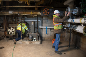Steam Station Personnel Working On Steam Pipes 