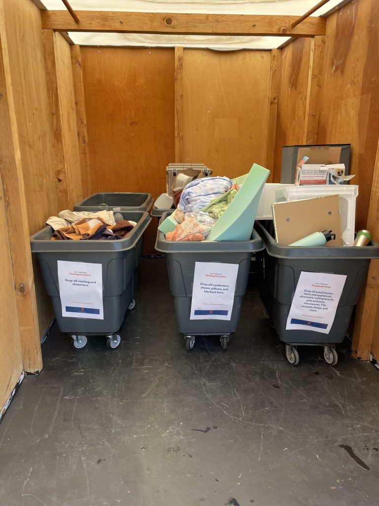 Gray bins are filled with student donations.