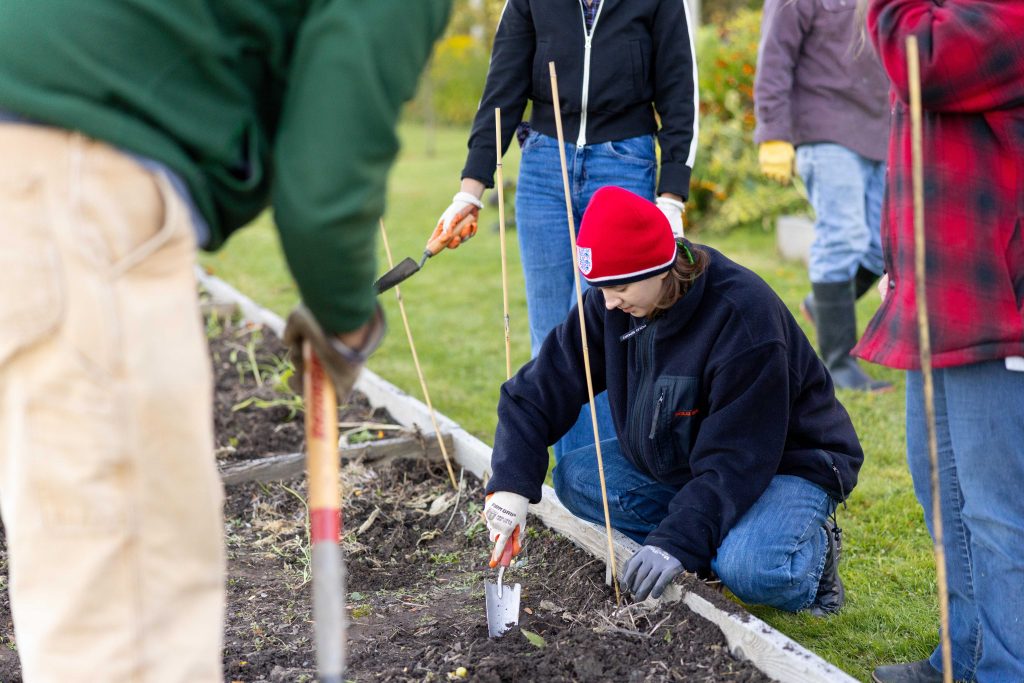 Student tending to garden. 