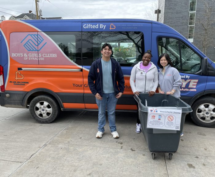 Intern and volunteer help load Boys & Girl Club van with donations.